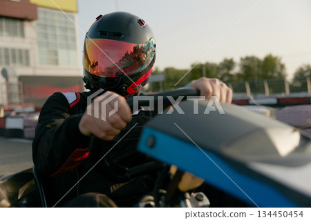 Portrait of a passionate racer skillfully drives a gokart 134450454