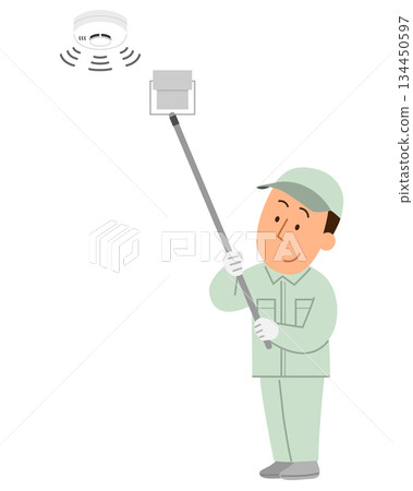 Male worker inspecting a fire alarm 1 134450597