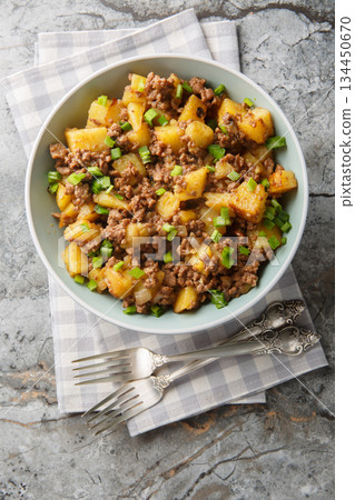 Ground Beef and Potato Stir-Fry closeup on the plate. Vertical top view 134450670