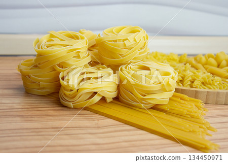 Pasta nests spaghetti scallops, linguini, penne tagliatelle fusilli spirals, Pasta nests spaghetti scallops, linguini, penne tagliatelle fusilli spirals, 134450971