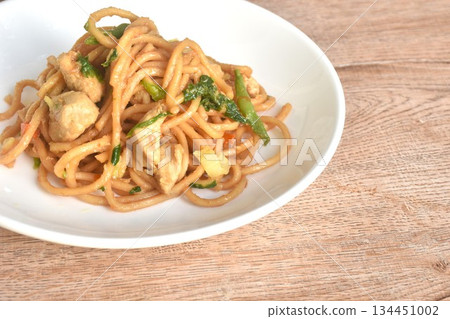 fried Chinese noodles slice chicken and celery in soy sauce on plate fried Chinese noodles slice chicken and celery in soy sauce on plate 134451002