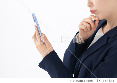 Woman operating a smartphone 134452184