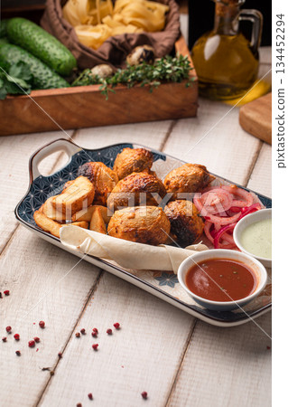 Grilled champignon mushroom skewers with sauce Grilled champignon mushroom skewers with sauce 134452294