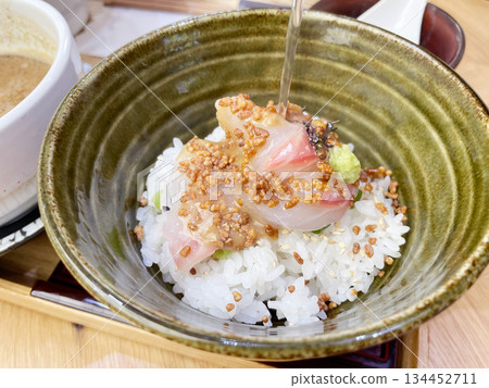 Sea bream rice porridge: Rice porridge with sea bream sashimi served with sesame sauce. 134452711