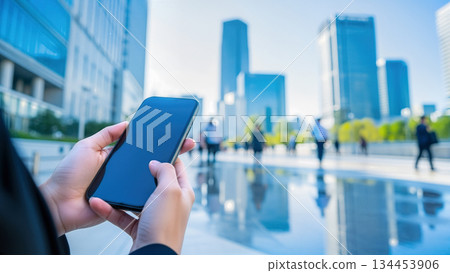 Image of smartphones and 5G communication networks/DX in a business district 134453906