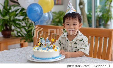 Happy Little Boy Enjoying His Colorful Birthday Cake with Big Smile 134454301