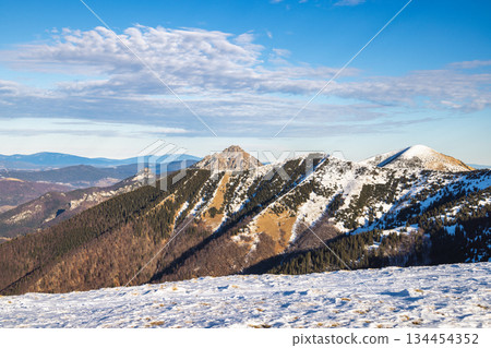 Snow-capped mountain range under a blue sky. The Mala Fatra national park in northwest of Slovakia, Europe. 134454352