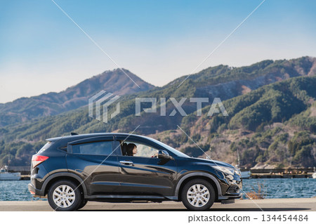 A young woman driving a car A young woman driving a car 134454484