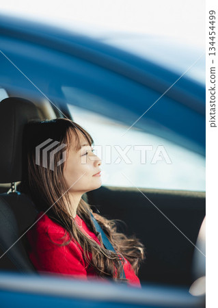 A young woman driving a car A young woman driving a car 134454499