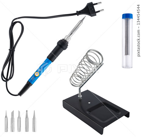 Compact soldering iron with stand, set of tips, and solder, on a white background in insulation. 134454544
