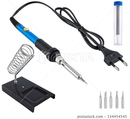 Compact soldering iron with stand, set of tips, and solder, on a white background in insulation. 134454545