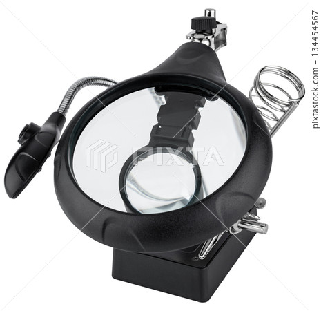 Tool for soldering boards with a magnifying glass and holders. On a white background 134454567