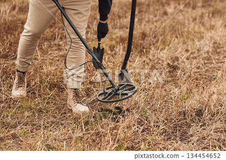 Sensitive sensor, searching. Man is with metal detector in the field Sensitive sensor, searching. Man is with metal detector in the field 134454652