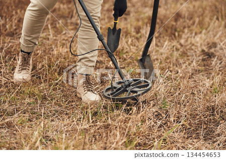 Sensitive sensor, searching. Man is with metal detector in the field Sensitive sensor, searching. Man is with metal detector in the field 134454653