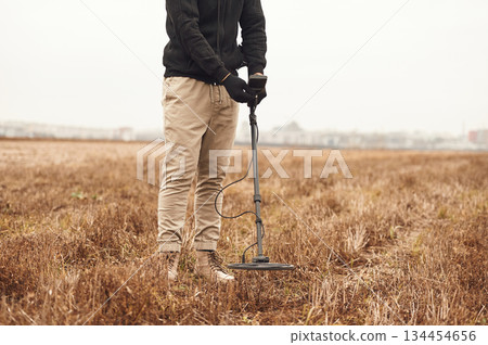In the field. Man is with metal detector In the field. Man is with metal detector 134454656
