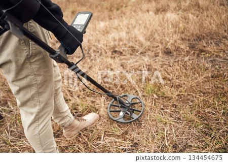 Sensitive sensor, searching. Man is with metal detector in the field Sensitive sensor, searching. Man is with metal detector in the field 134454675