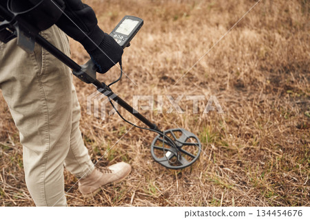 Information on the display. Man is with metal detector in the field 134454676