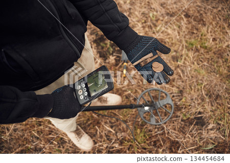 Old bullets and coin. Man is with metal detector in the field Old bullets and coin. Man is with metal detector in the field 134454684