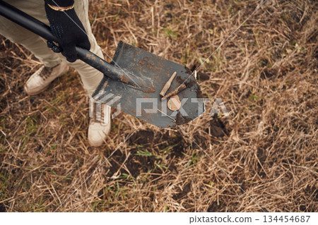 Man found old bullets and coin, sapper, close up view, with shovel Man found old bullets and coin, sapper, close up view, with shovel 134454687