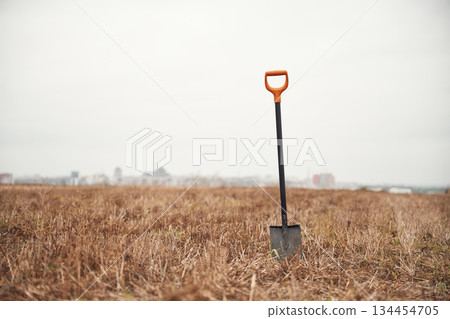 Shovel is on the autumn field, conception of sapper job Shovel is on the autumn field, conception of sapper job 134454705