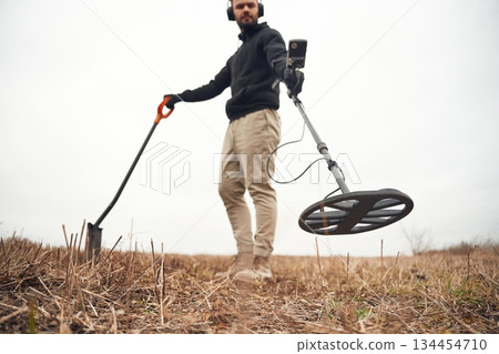 View from below. Man is with metal detector in the field View from below. Man is with metal detector in the field 134454710