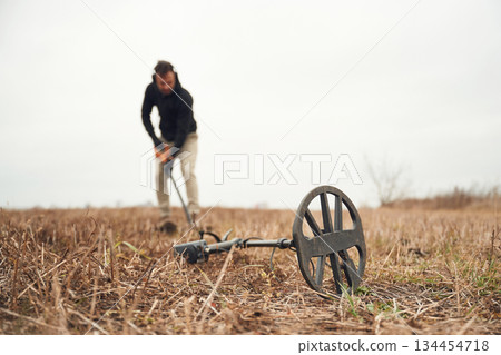 Digging the hole. Man is with metal detector in the field Digging the hole. Man is with metal detector in the field 134454718