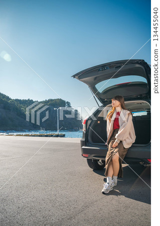 A young woman driving to the sea on a sunny day A young woman driving to the sea on a sunny day 134455040