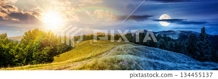 panorama of mountain ridge. day and night time change concept. country dirt road runs through grassy meadow near forest with sun and moon. location for hiking. harmony and progress calendar 134455137