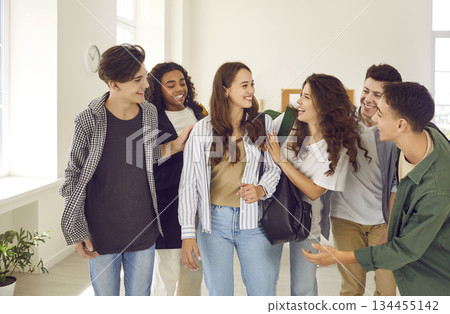 Group of happy teenage school boys and girls meet and make friends with a new student Group of happy teenage school boys and girls meet and make friends with a new student 134455142