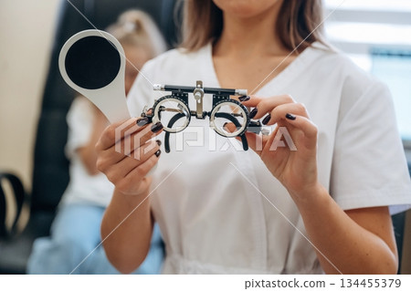 Little girl at the ophthalmologist clinic with doctor Little girl at the ophthalmologist clinic with doctor 134455379