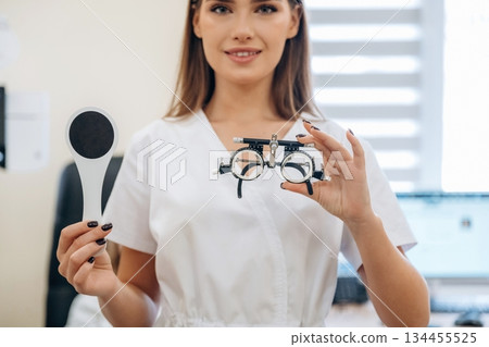 Young female ophthalmologist is in the cabinet 134455525