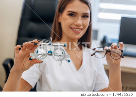 Gorgeous young female ophthalmologist is in the cabinet Gorgeous young female ophthalmologist is in the cabinet 134455530