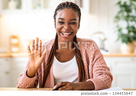 Joyful black woman making video call with laptop in kitchen interior, waving at screen, cheerful african american female having online web conference at home, screenshot image from device, collage Joyful black woman making video call with laptop in kitchen interior, waving at screen, cheerful african american female having online web conference at home, screenshot image from device, collage 134455647