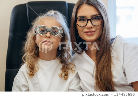 Little girl at the ophthalmologist clinic with doctor Little girl at the ophthalmologist clinic with doctor 134455696