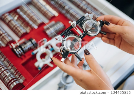 Bunch of objects. Ophthalmologist is picking different lenses that are in the kit 134455835