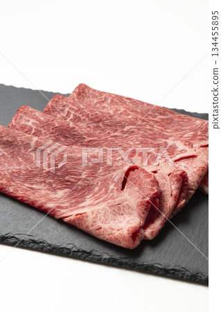 Beef on a black plate on a white background 134455895