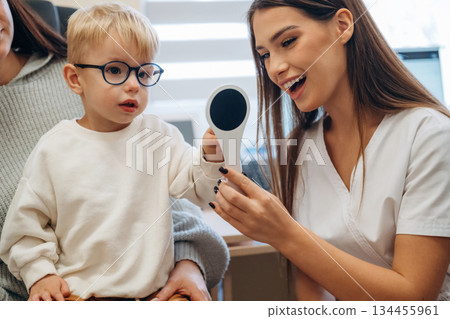 Little boy is having check up in the ophthalmologist cabinet Little boy is having check up in the ophthalmologist cabinet 134455961