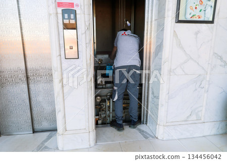 Egypt, Sharm el-Sheikh - October 2, 2025 A worker repairs an elevator at the Savoy Hotel. Editorial 134456042