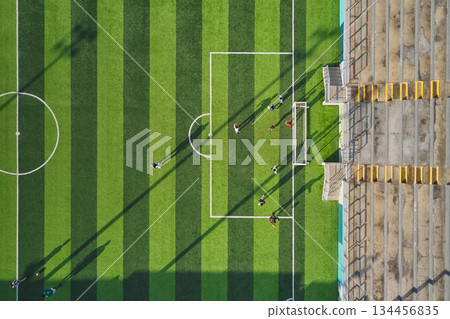 Football players playing soccer match on green field 134456835