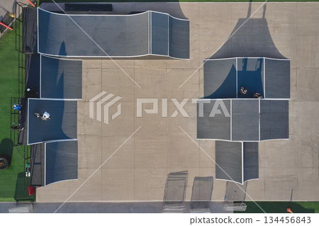 Skatepark aerial view with bmx riders on ramps Skatepark aerial view with bmx riders on ramps 134456843