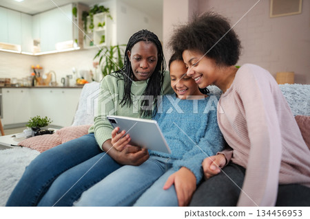 African American family bonding with tablet at home 134456953