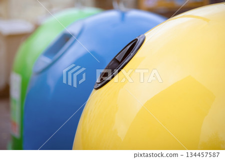 Outdoor Shot Of Different Colorful Garbage Containers For Waste Sorting, Image Of Yellow Blue And Green Trash Recycling Bin For Diverse Kind Of Waste, Closeup With Selective Focus Outdoor Shot Of Different Colorful Garbage Containers For Waste Sorting, Image Of Yellow Blue And Green Trash Recycling Bin For Diverse Kind Of Waste, Closeup With Selective Focus 134457587