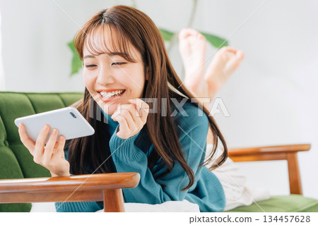 Woman watching video on smartphone 134457628