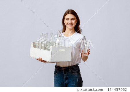 Happy Young Woman Collecting Garbage For Sorting, Holding Container With Empty Glass Bottles For Reuse, Smiling Millennial Lady Holding Wooden Box With Waste Materials For Recycling, Copy Space 134457962