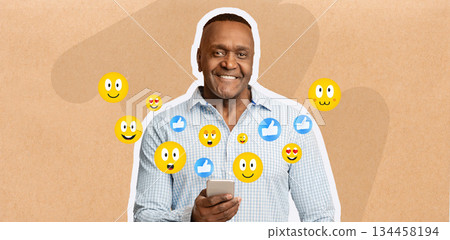 African American man smiles while texting on his smartphone, engaging with friends on social media. He appears happy and connected, surrounded by emojis that express joy and positivity. African American man smiles while texting on his smartphone, engaging with friends on social media. He appears happy and connected, surrounded by emojis that express joy and positivity. 134458194