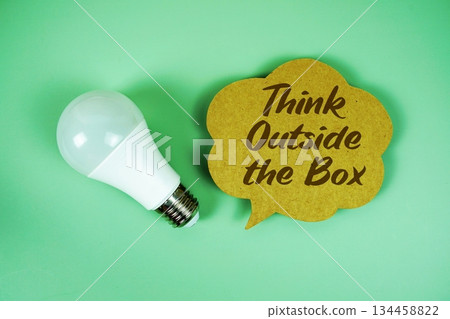 Think Outside the Box text written on speed bubble with light bulb Think Outside the Box text written on speed bubble with light bulb 134458822
