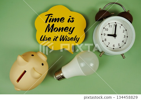 Time is Money, Use it Wisely text written on speed bubble with light bulb, piggy bank and alarm clock Time is Money, Use it Wisely text written on speed bubble with light bulb, piggy bank and alarm clock 134458829
