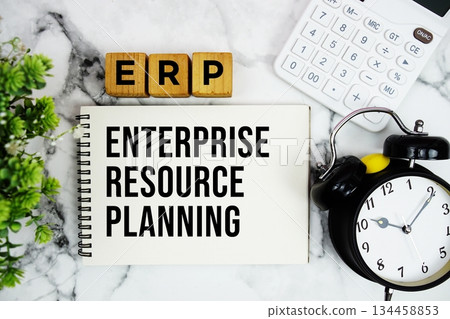 ERP Enterprise Resource Planning text with calculator and alarm clock on marble background 134458853