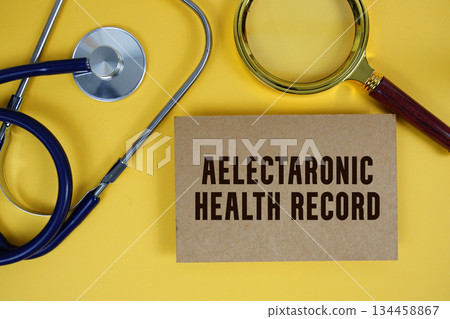 EHR Electronic Health Record text on paper card with Stethoscope flat lay on yellow background 134458867
