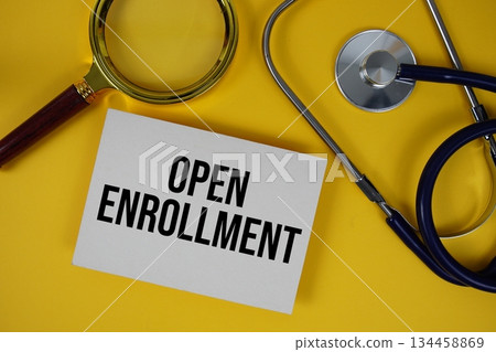 Open Enrollment text on paper card with Stethoscope flat lay on yellow background Open Enrollment text on paper card with Stethoscope flat lay on yellow background 134458869